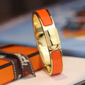 HERMES H LOCK ORANGE GOLD BRACELET 12MM